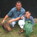 Lawai Dickens with son Pomai and pig Pork Chop