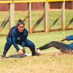 Alyssa Jardin gobbles up a low throw at third base in an attempt to halt the Punahou baserunner bearing down on her.