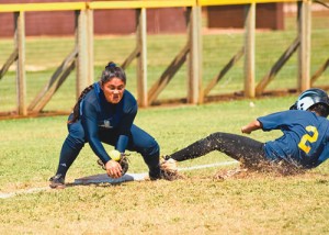 Alyssa Jardin gobbles up a low throw at third base in an attempt to halt the Punahou baserunner bearing down on her.